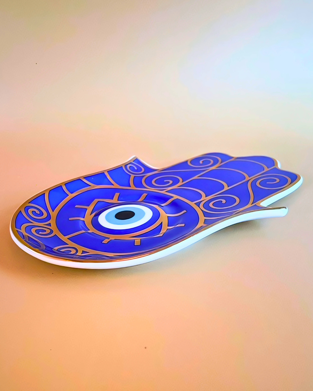 Decorative plate with blue and gold design on a gradient background