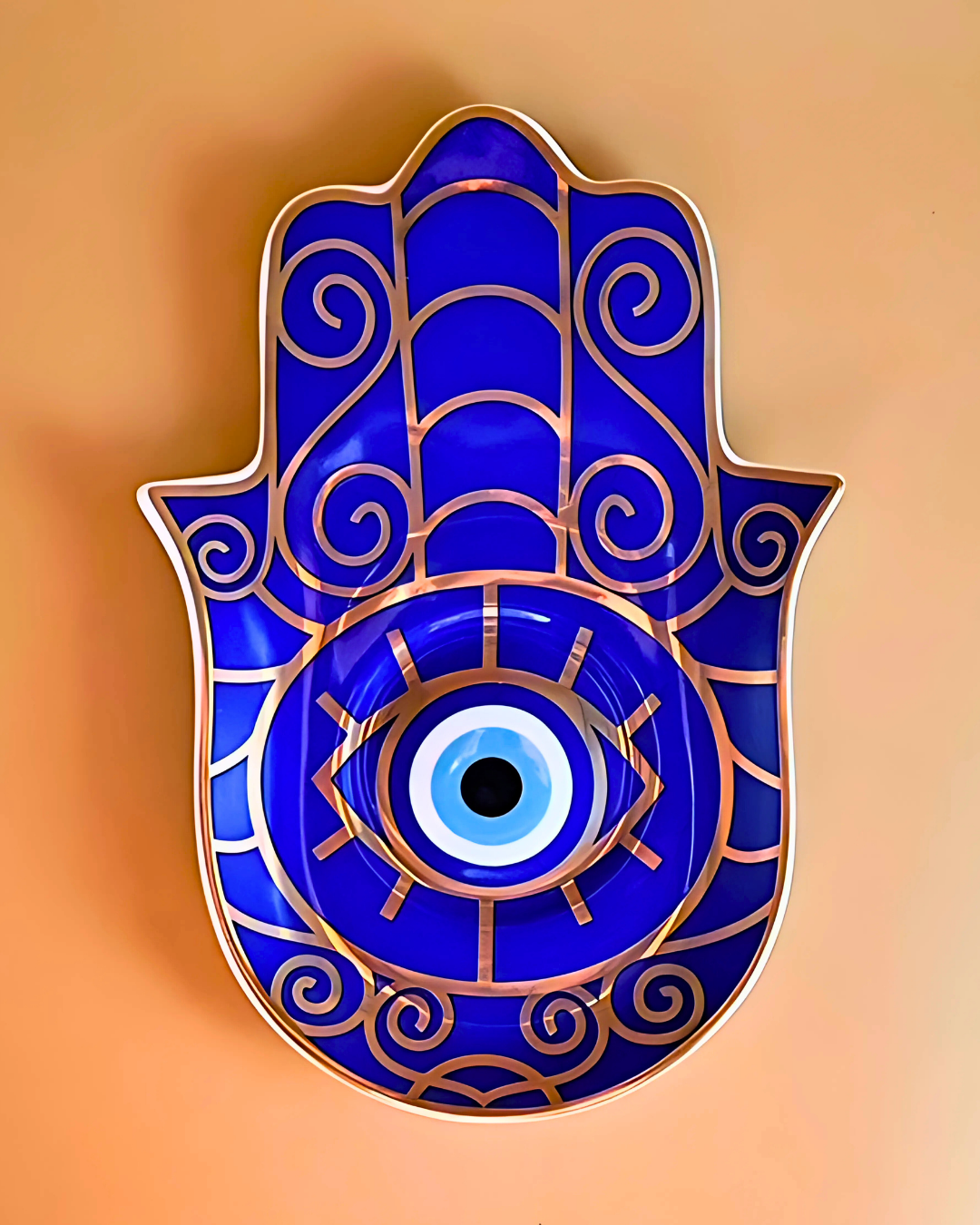 Blue Hamsa hand with eye design on a beige background