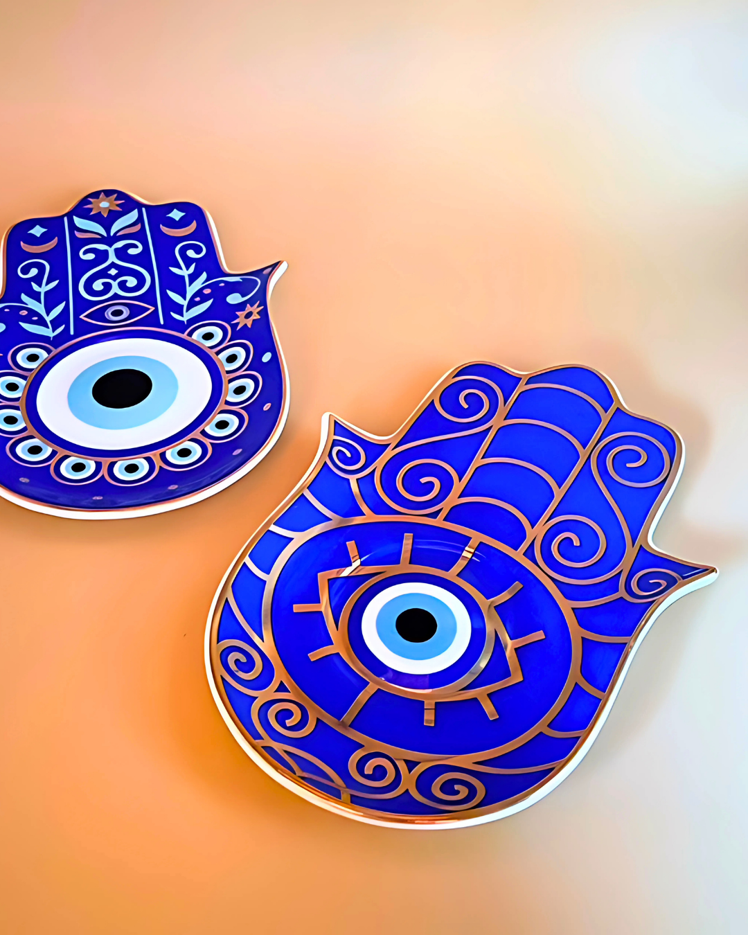 Two blue Hamsa hand decor items on a gradient background