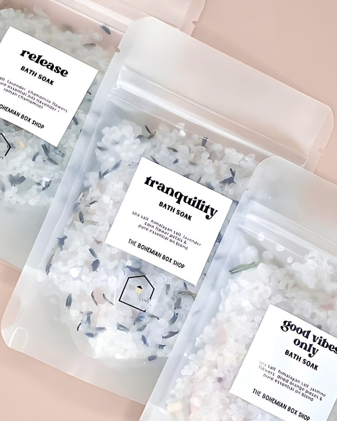 Bath soaks in clear packaging with labels on a pink background