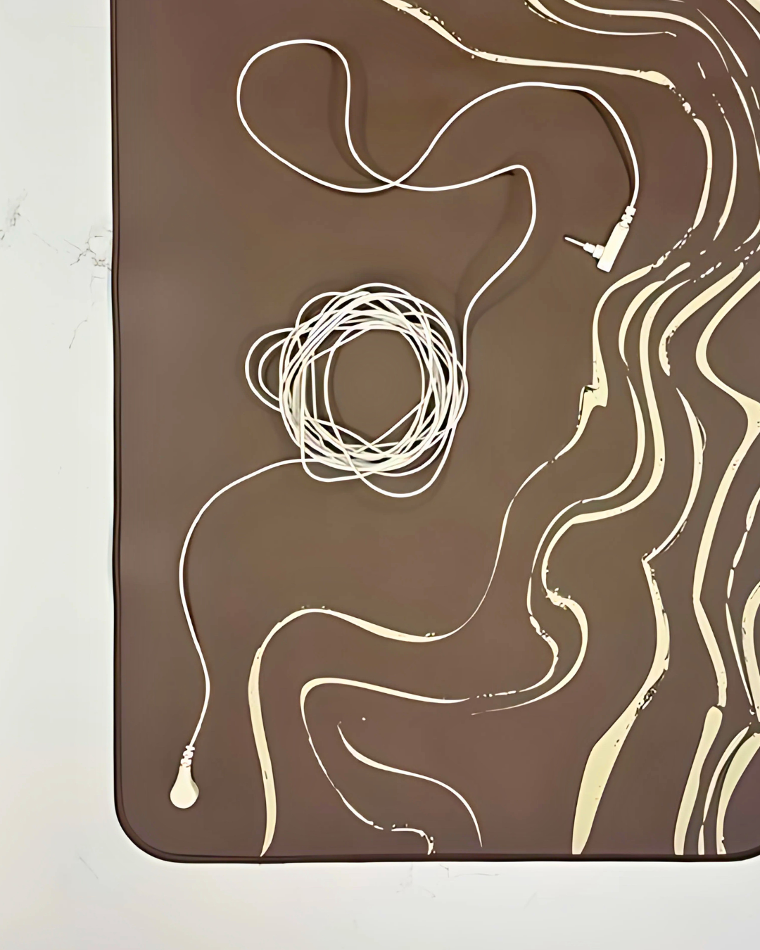 Abstract design with wavy lines and a coil on a brown background
