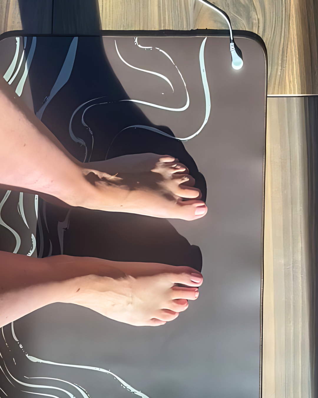 Person's feet on a transparent scale with a wooden floor background