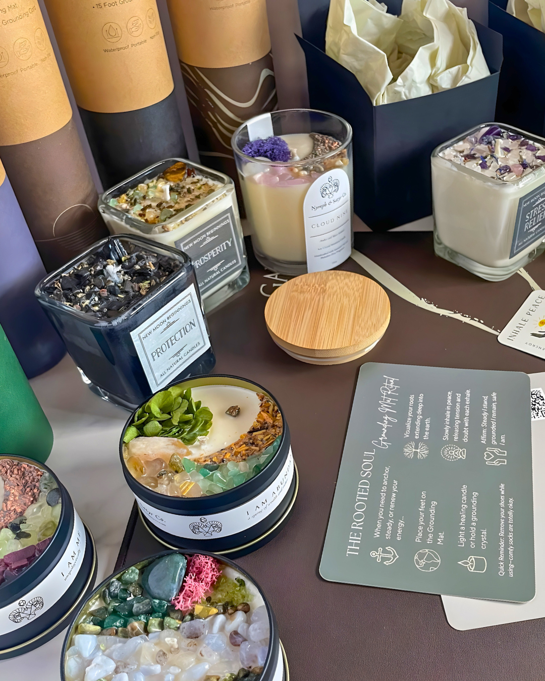 Collection of candles and decorative items on a table with visible branding.