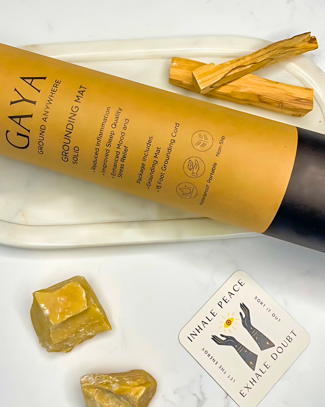 GAYA grounding mat with yellow crystals and a card on a white surface