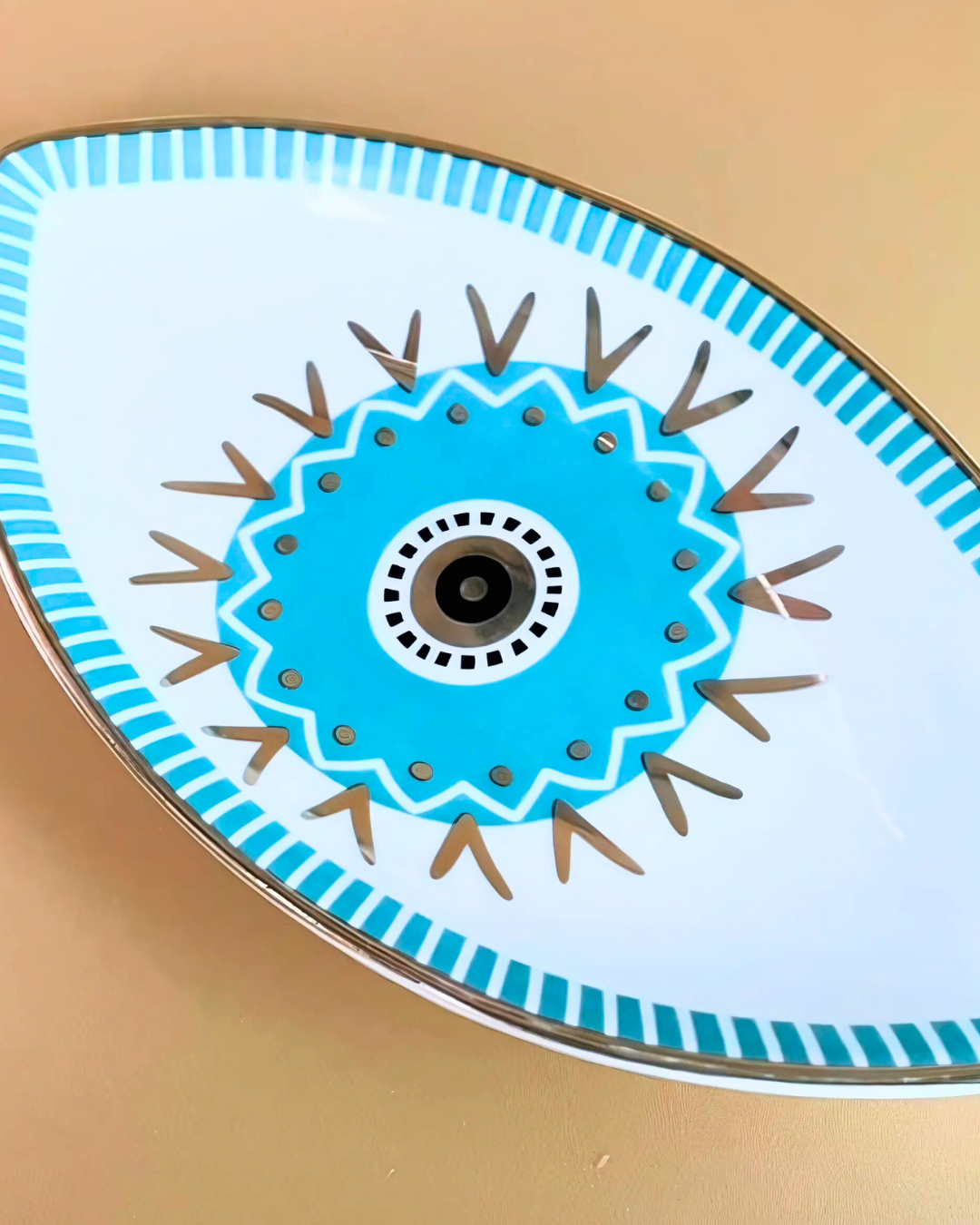Decorative plate with blue and brown geometric design on a beige background