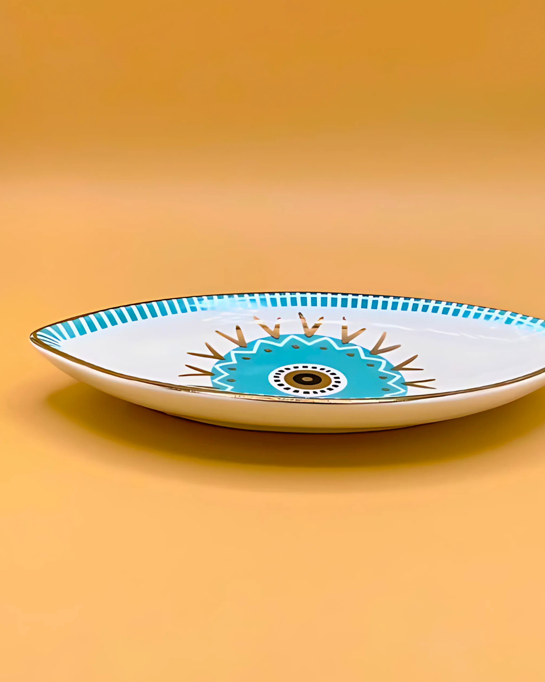 Decorative plate with a blue and white design on an orange background