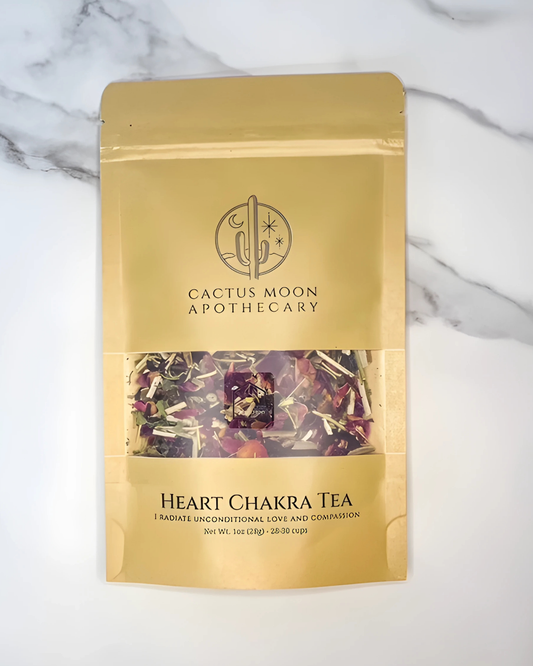 Gold packaging of Cactus Moon Apothecary Heart Chakra Tea on a marble background