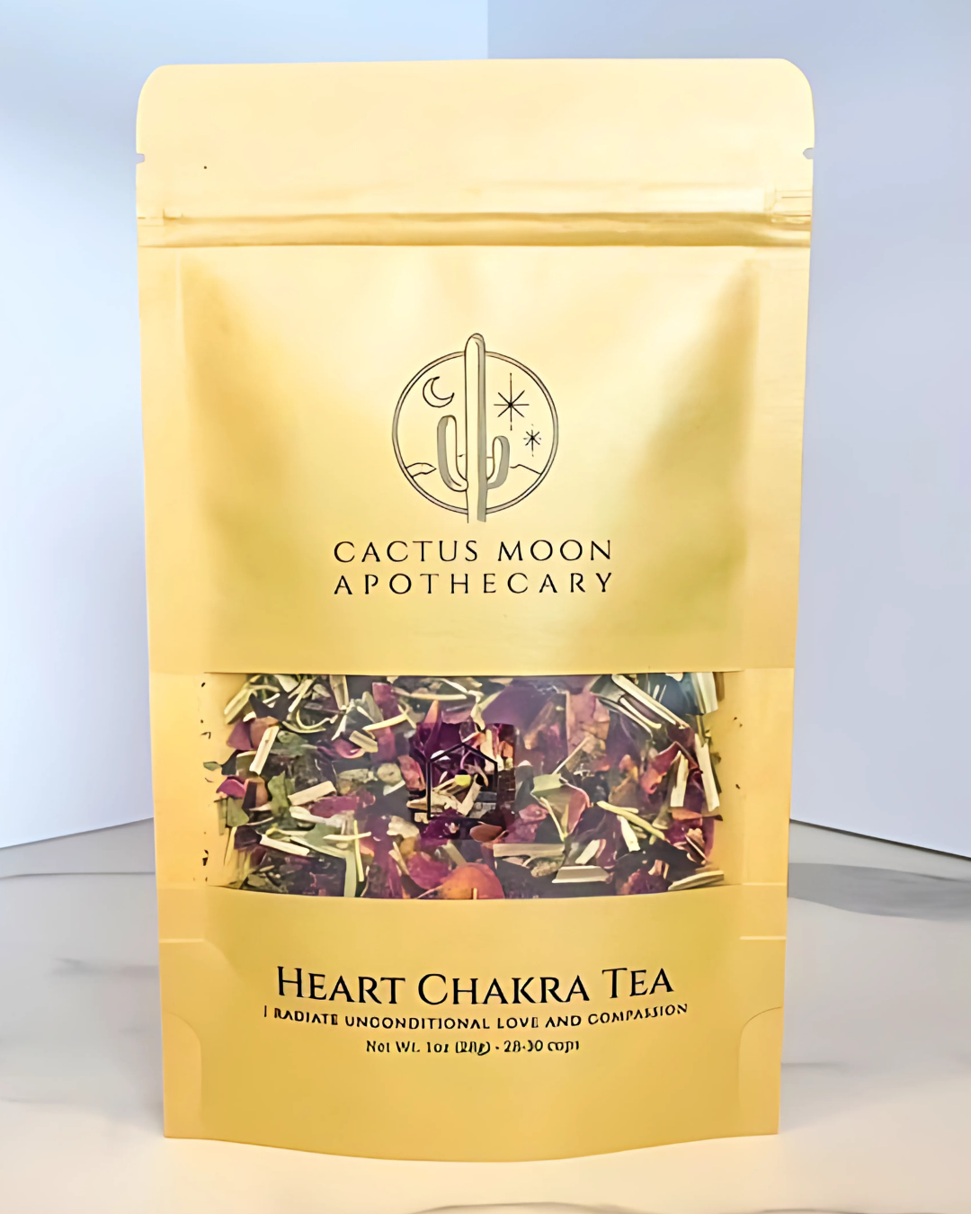 Yellow package of Heart Chakra Tea from Cactus Moon Apothecary on a light gray background
