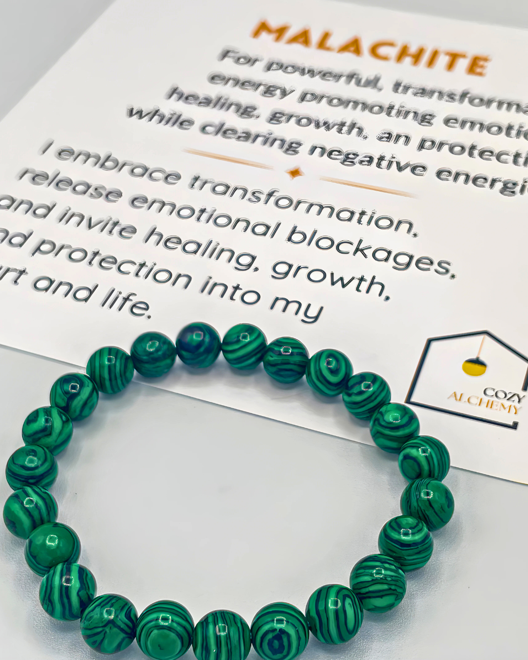 Green beaded bracelet on a Cozy Alchemy branded card