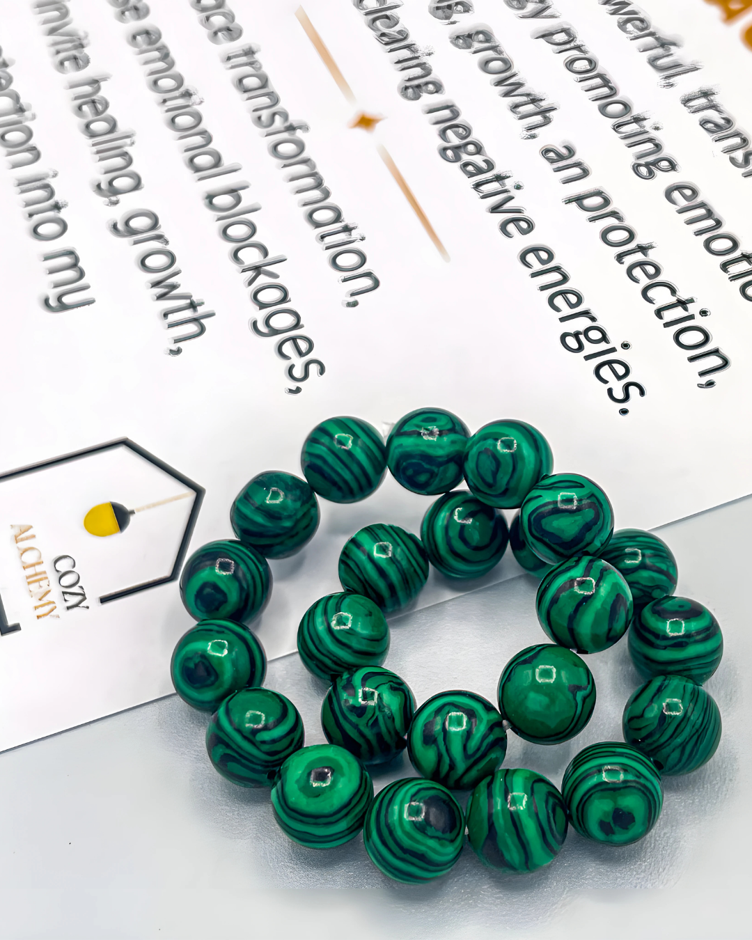 Green marbled beads on a white surface with text in the background