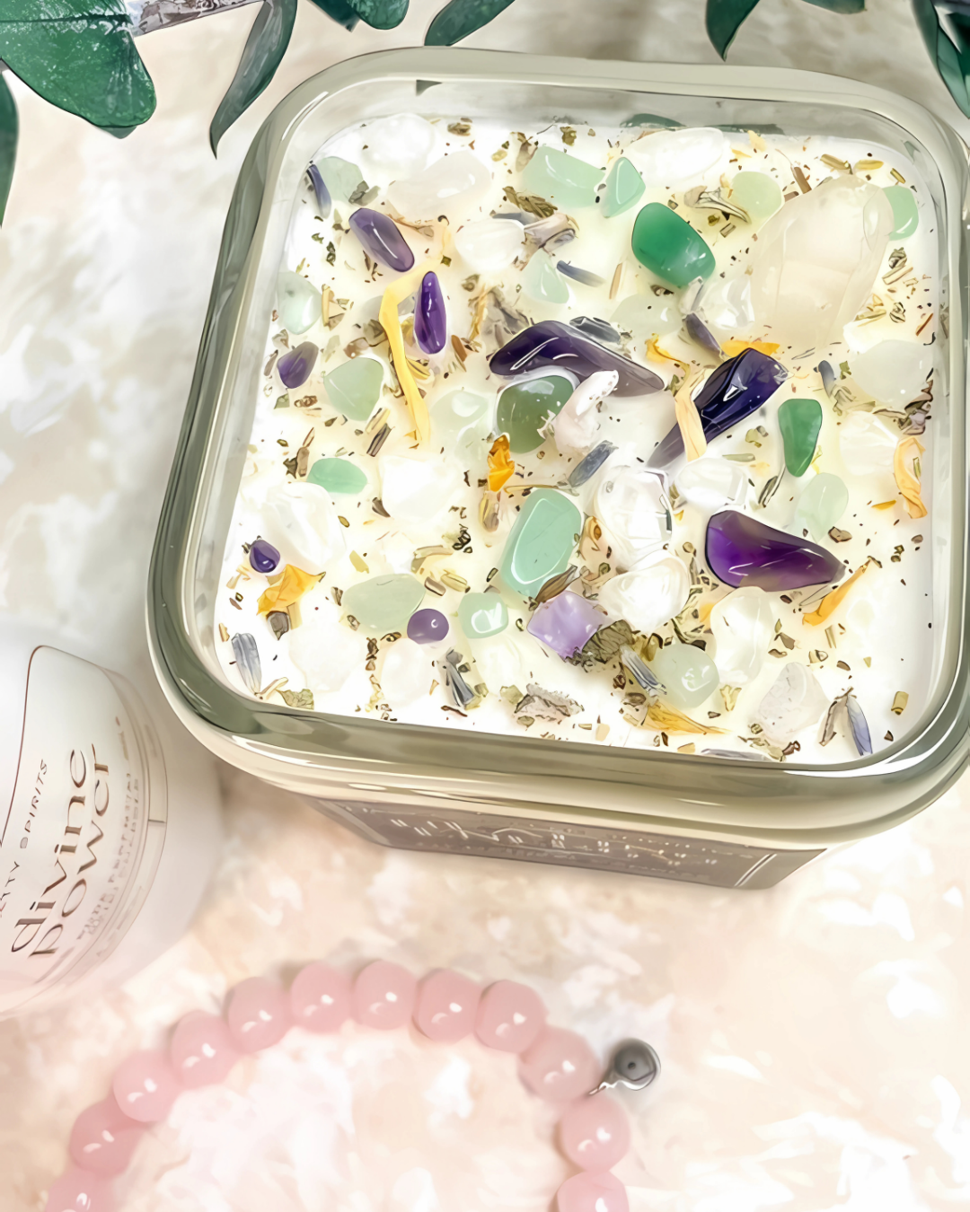 Container of decorative sand with colored stones on a soft surface