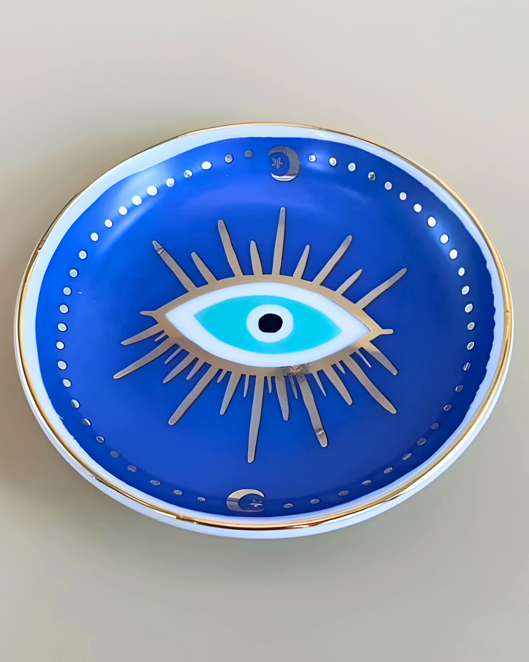 Decorative plate with an eye design on a blue background