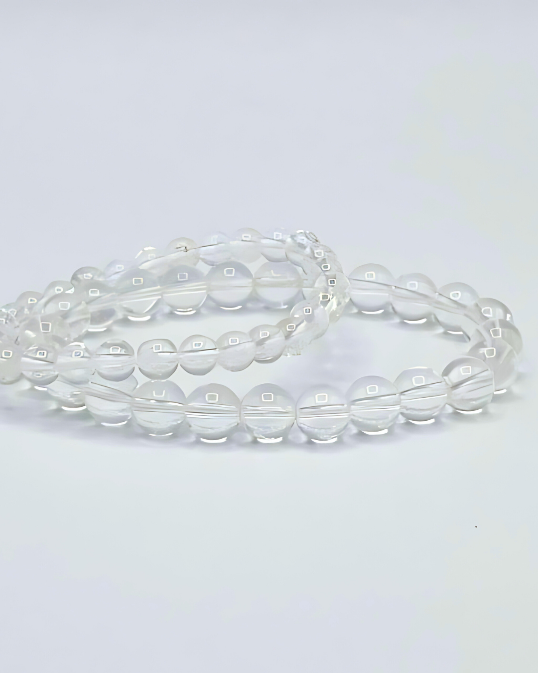 Clear beaded necklace on a light gray background