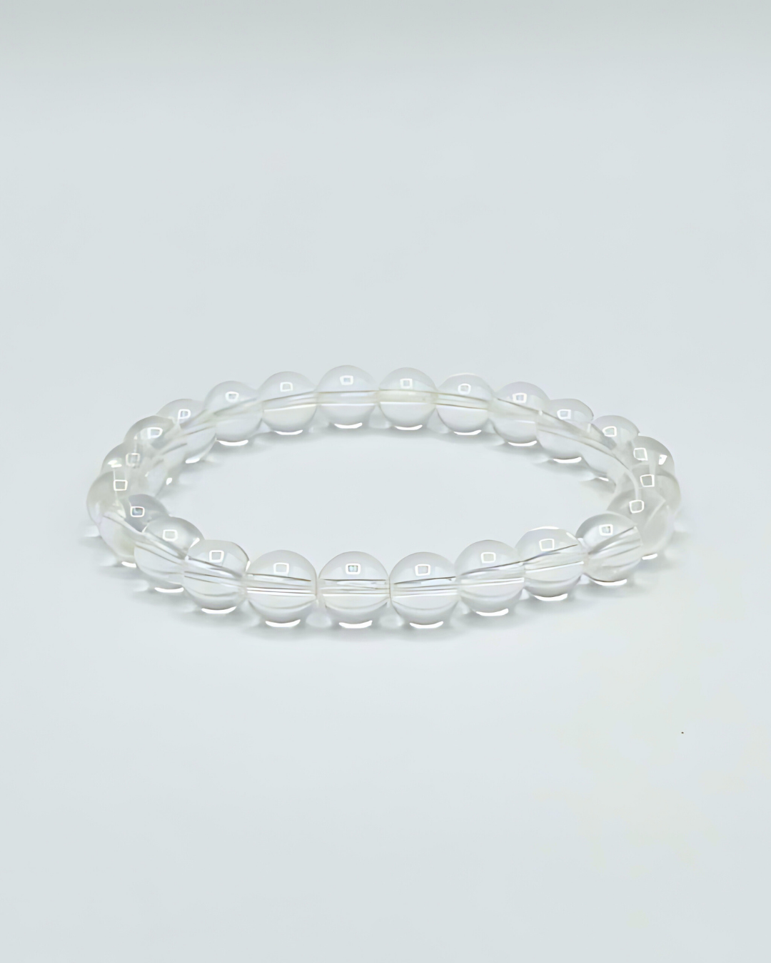 Clear beaded bracelet on a light gray background