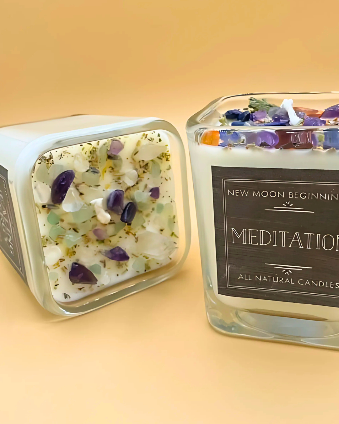 Two square candles with decorative elements on a beige background