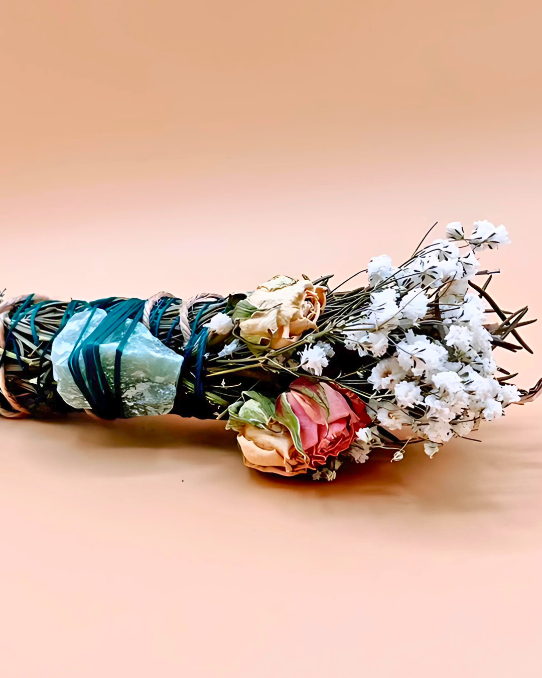 Bouquet of dried flowers with ribbons on a beige background