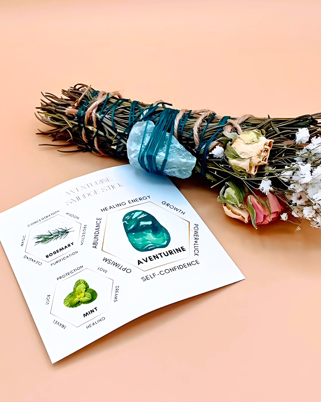 Bouquet of herbs with a green stone and a card on a peach background