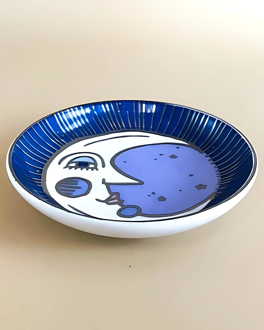 Ceramic plate with blue and white abstract design on a beige background