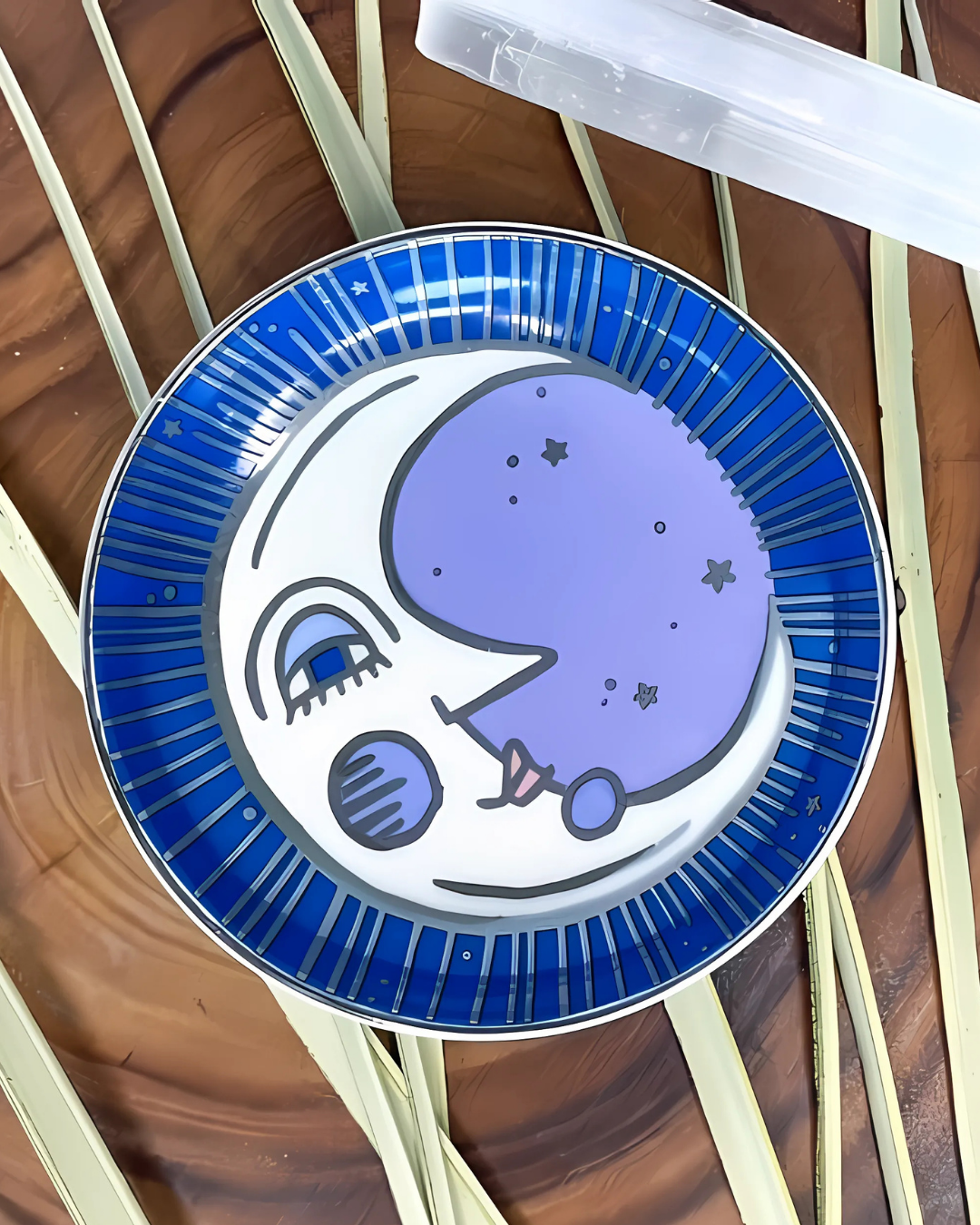 Decorative plate with a blue and white design on a wooden surface