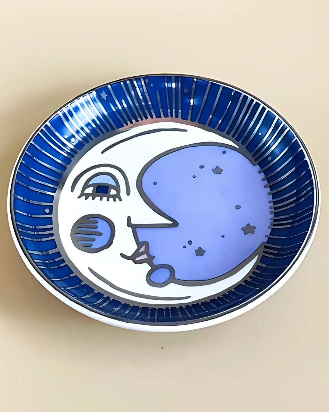 Ceramic plate with blue abstract design on a beige background
