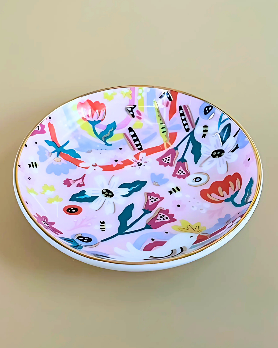 Decorative plate with colorful floral and abstract patterns on a beige background