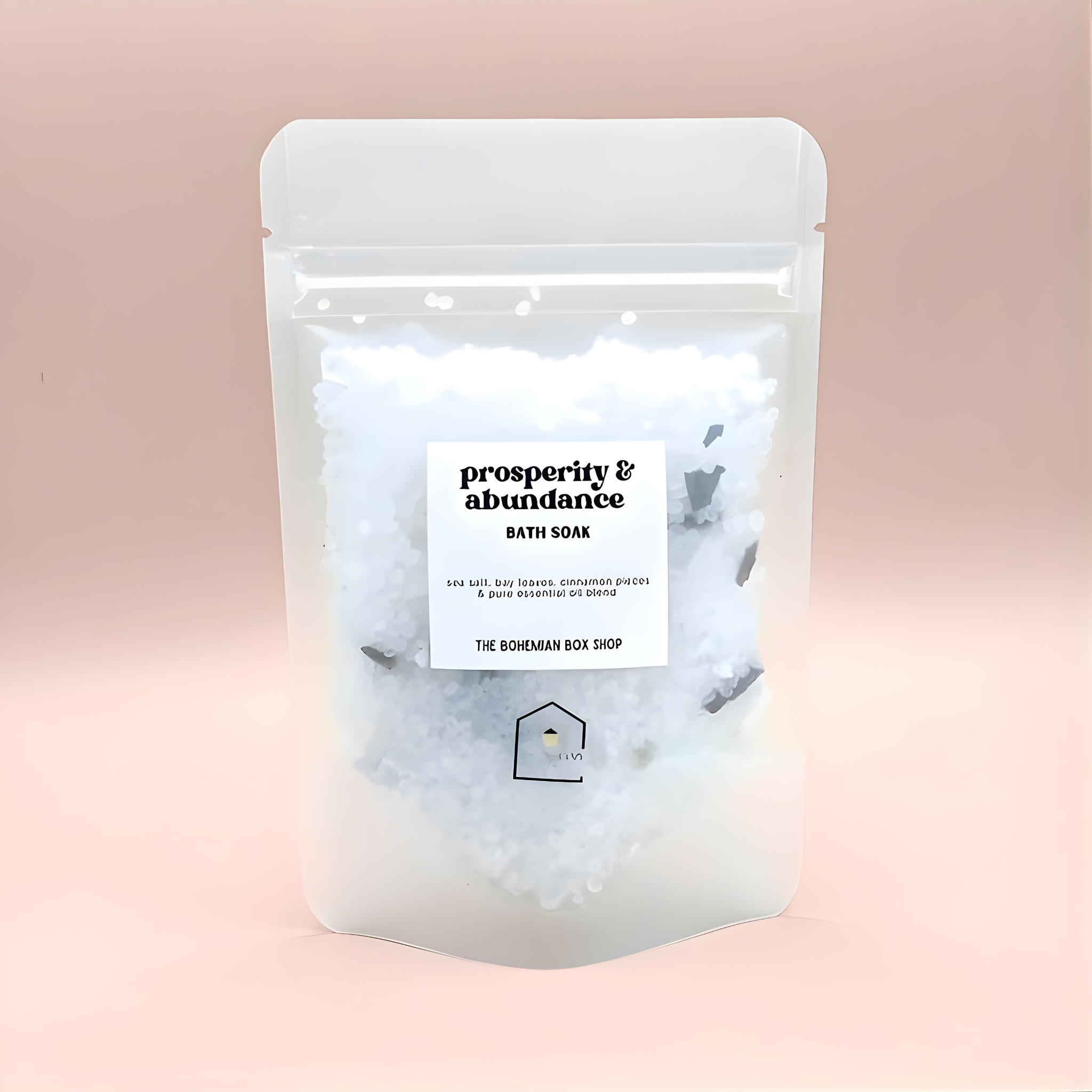 Bath soak package labeled 'Prosperity & Abundance' on a pink background