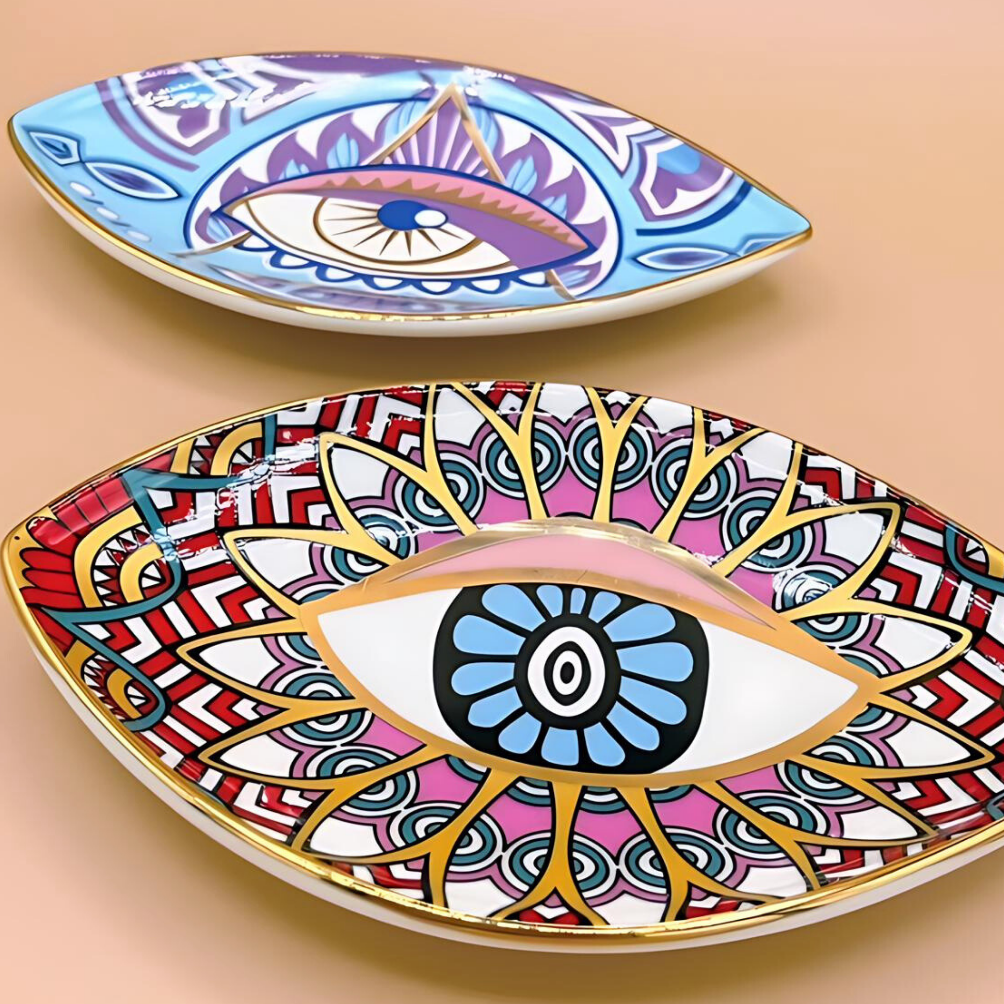 Two decorative plates with eye designs on a beige background