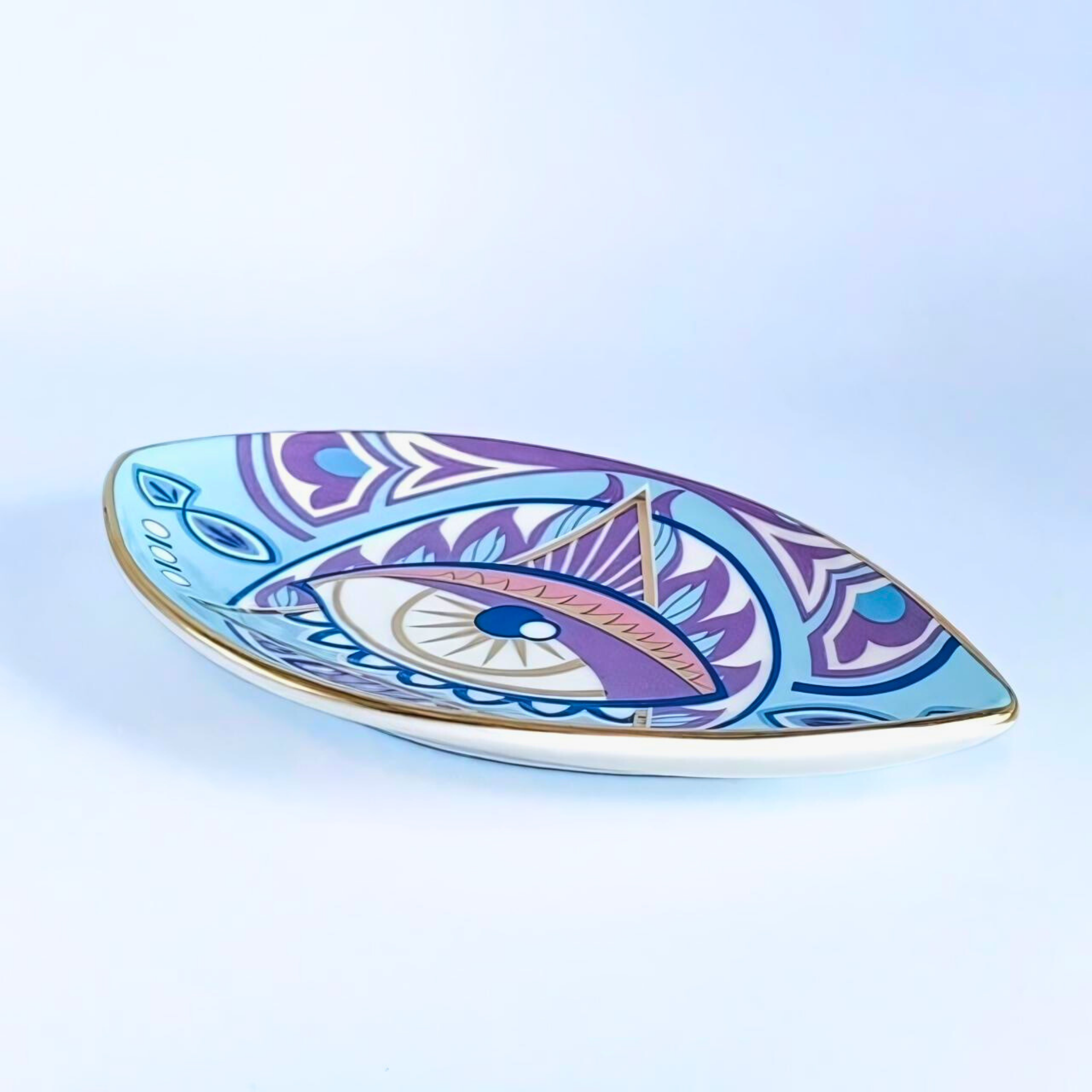 Decorative plate with eye design on a light blue background