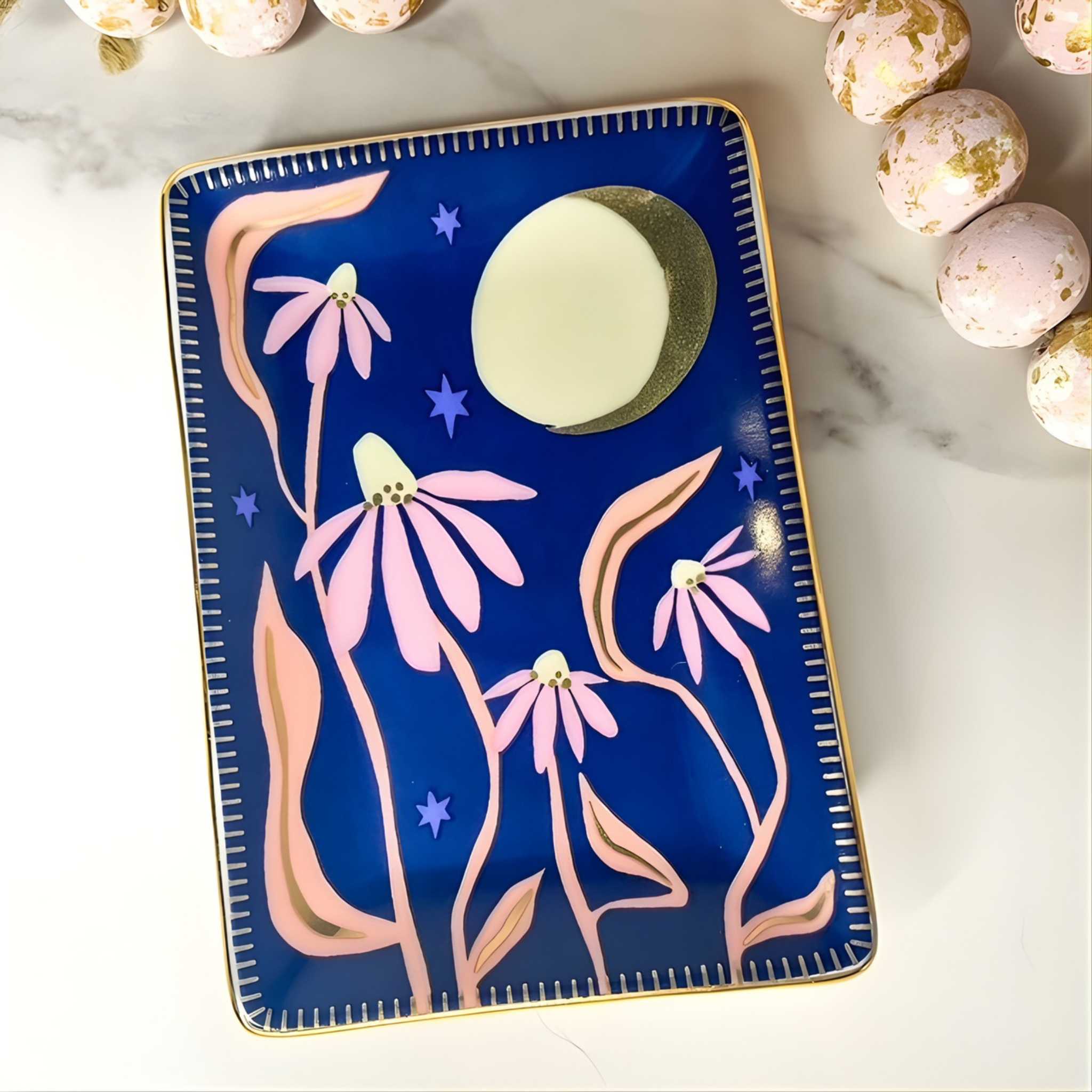 Decorative tray with floral design on a marble surface