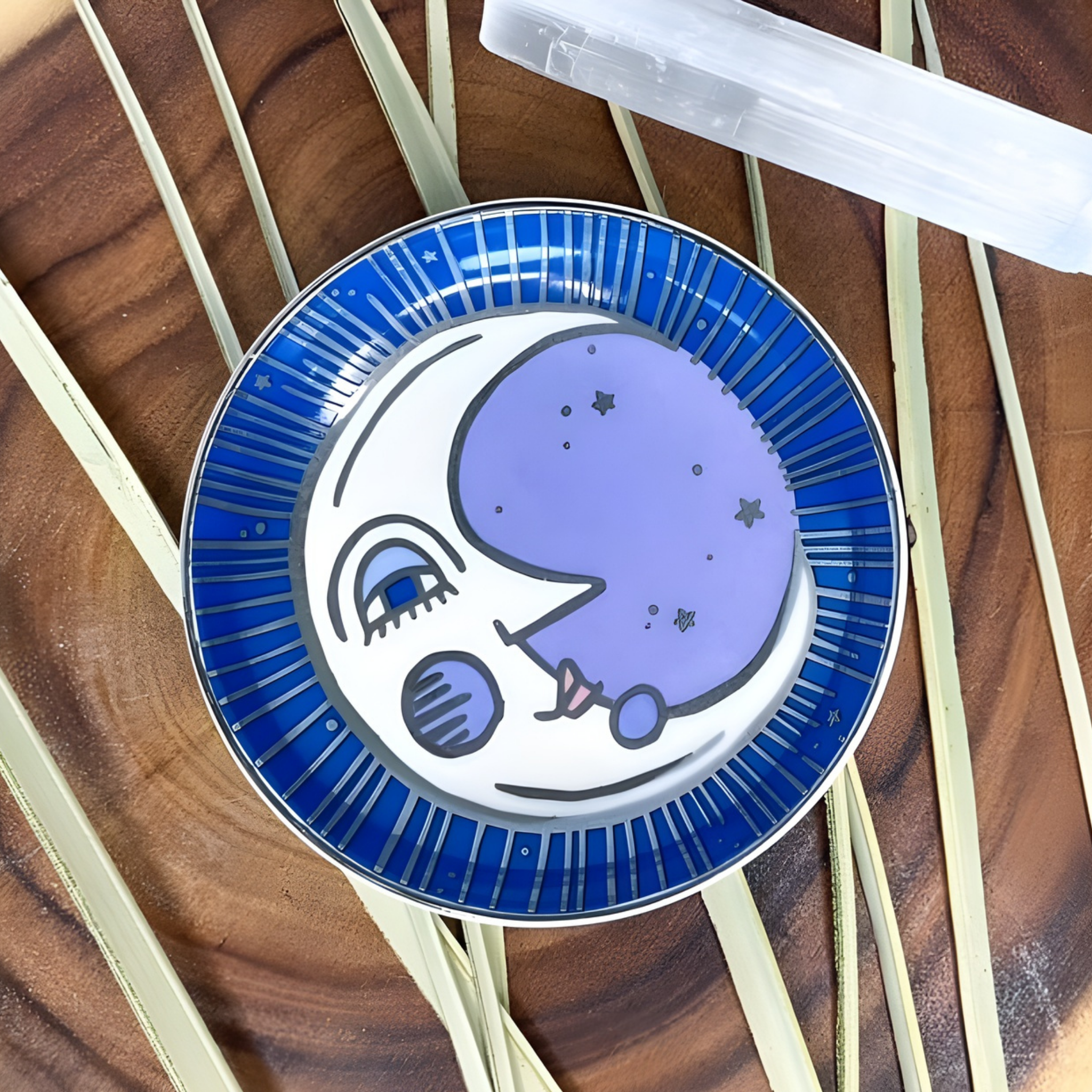 Decorative plate with a moon design on a wooden surface