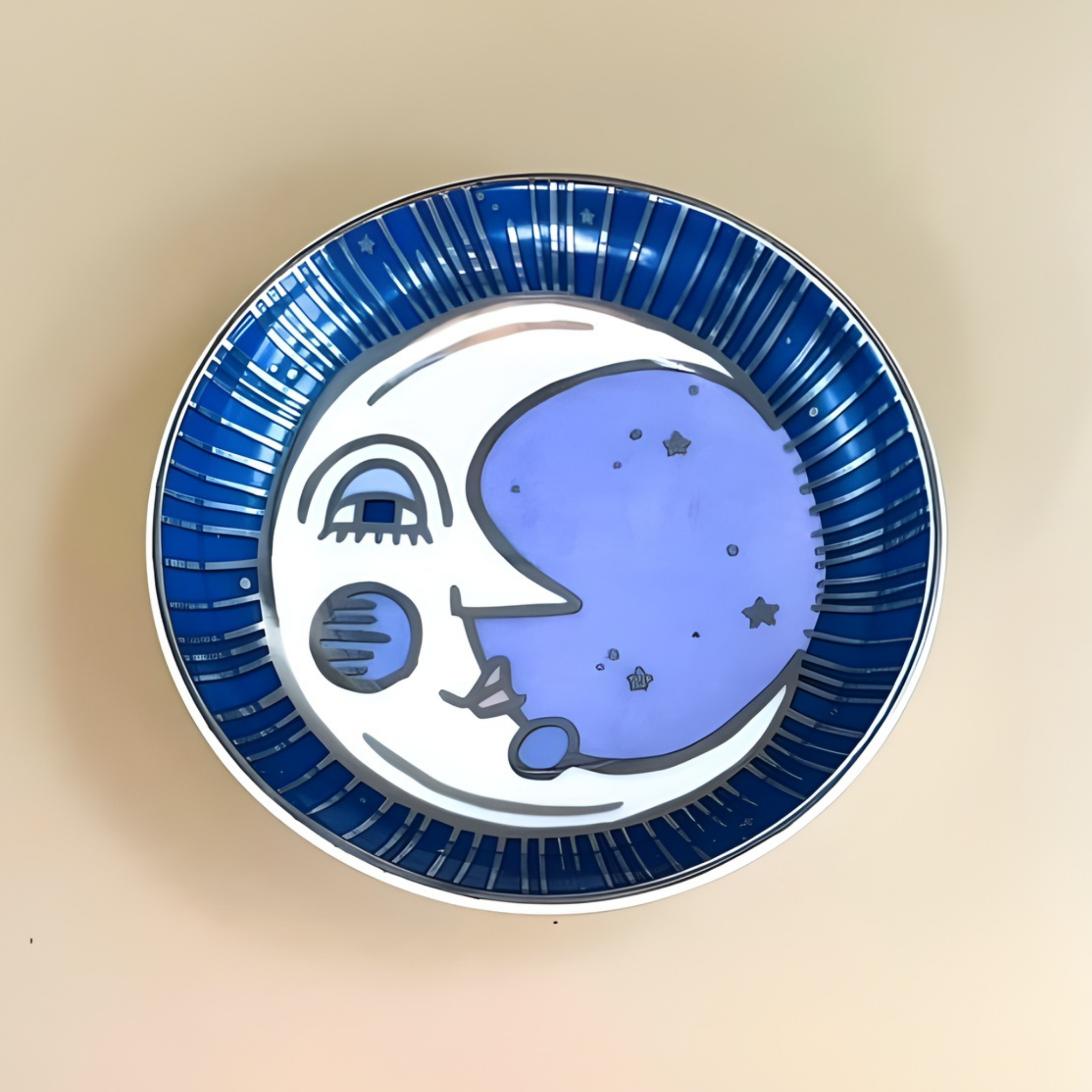 Ceramic plate with a blue and white moon design on a beige background