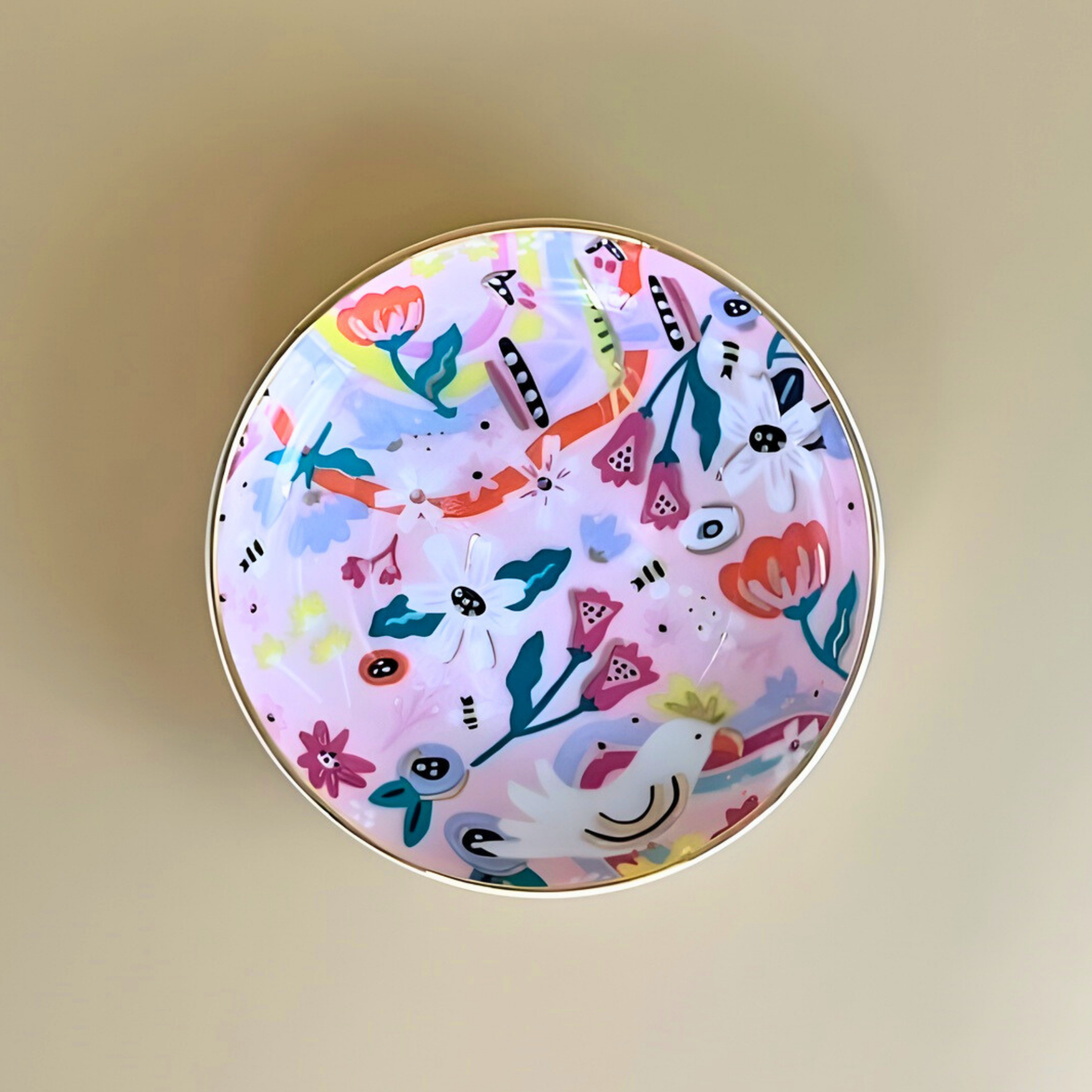 Round decorative item with colorful floral pattern on a beige background