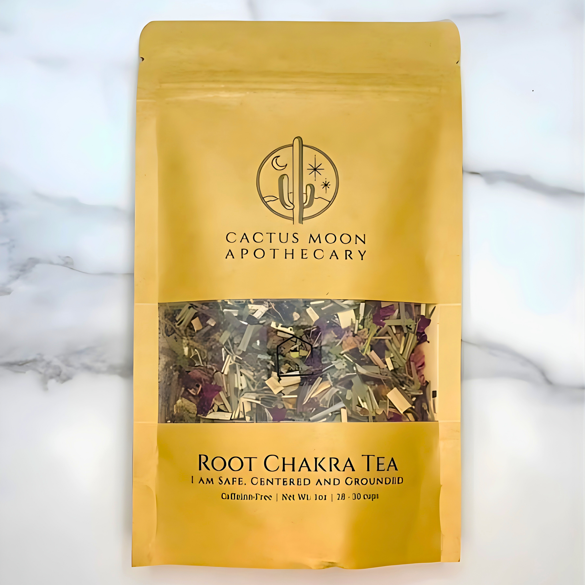Yellow package of Root Chakra Tea from Cactus Moon Apothecary on a marble background