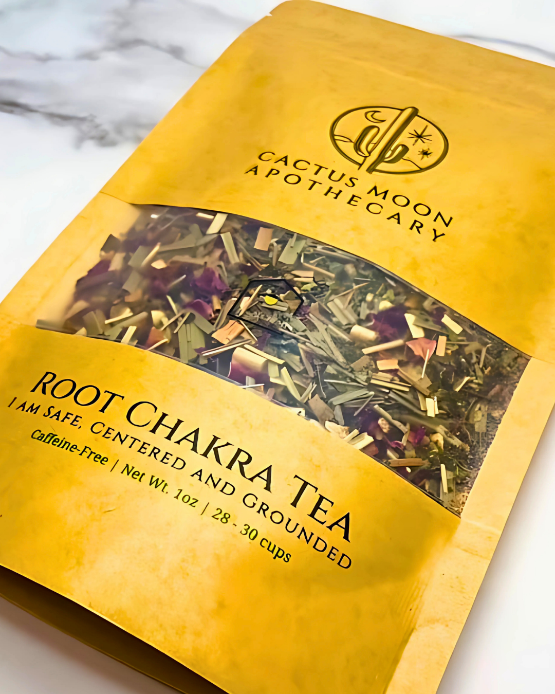 Yellow package of Root Chakra Tea from Cactus Moon Apothecary on a marble surface
