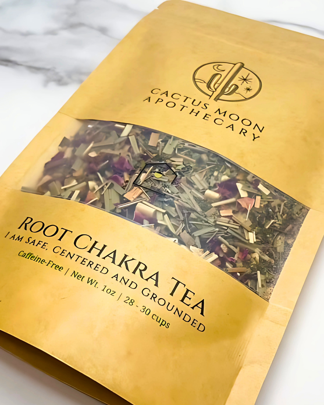 Gold package of Cactus Moon Apothecary Root Chakra Tea on a marble surface