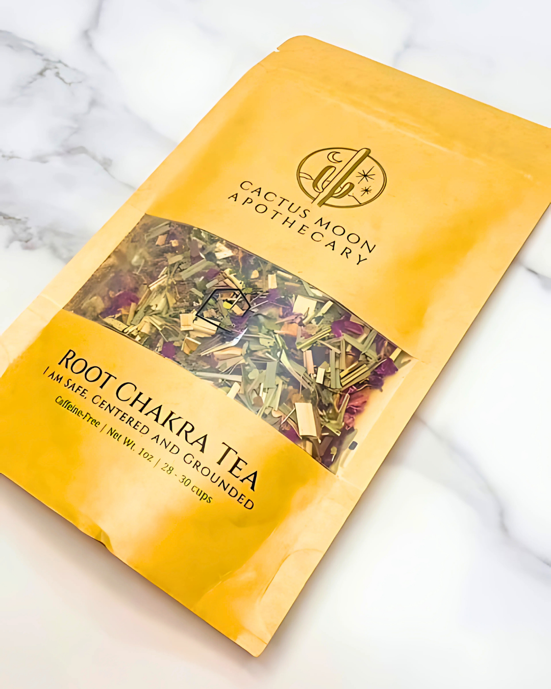 Yellow package of Root Chakra Tea from Cactus Moon Apothecary on a marble surface