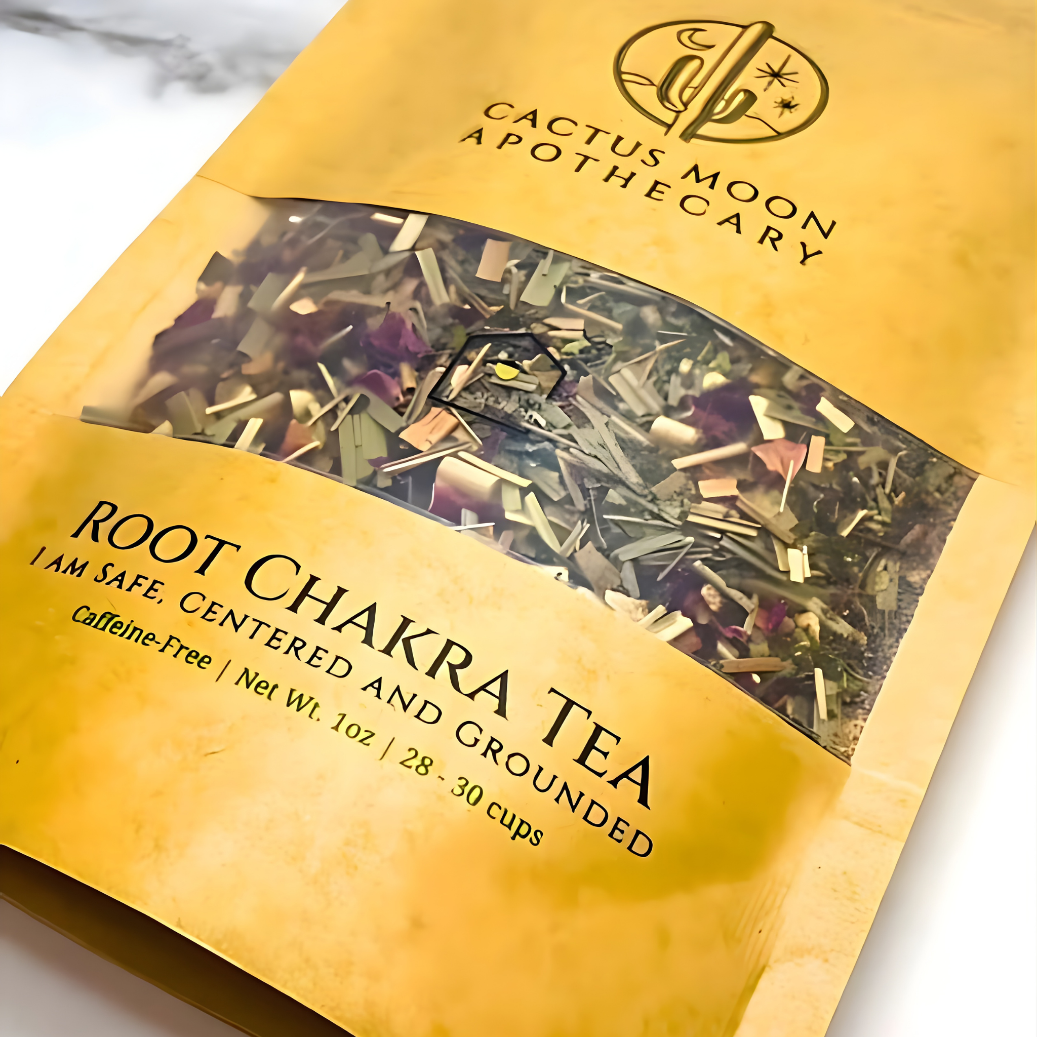 Yellow package of Root Chakra Tea from Cactus Moon Apothecary on a marble surface