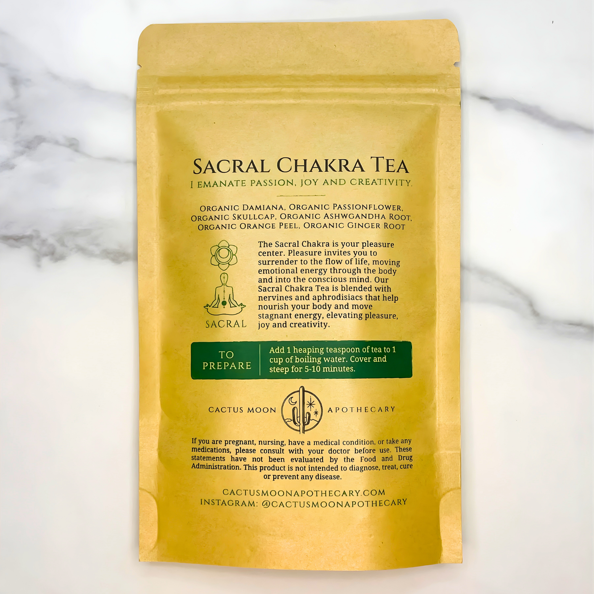 Sacral Chakra Tea package with text on a marble background