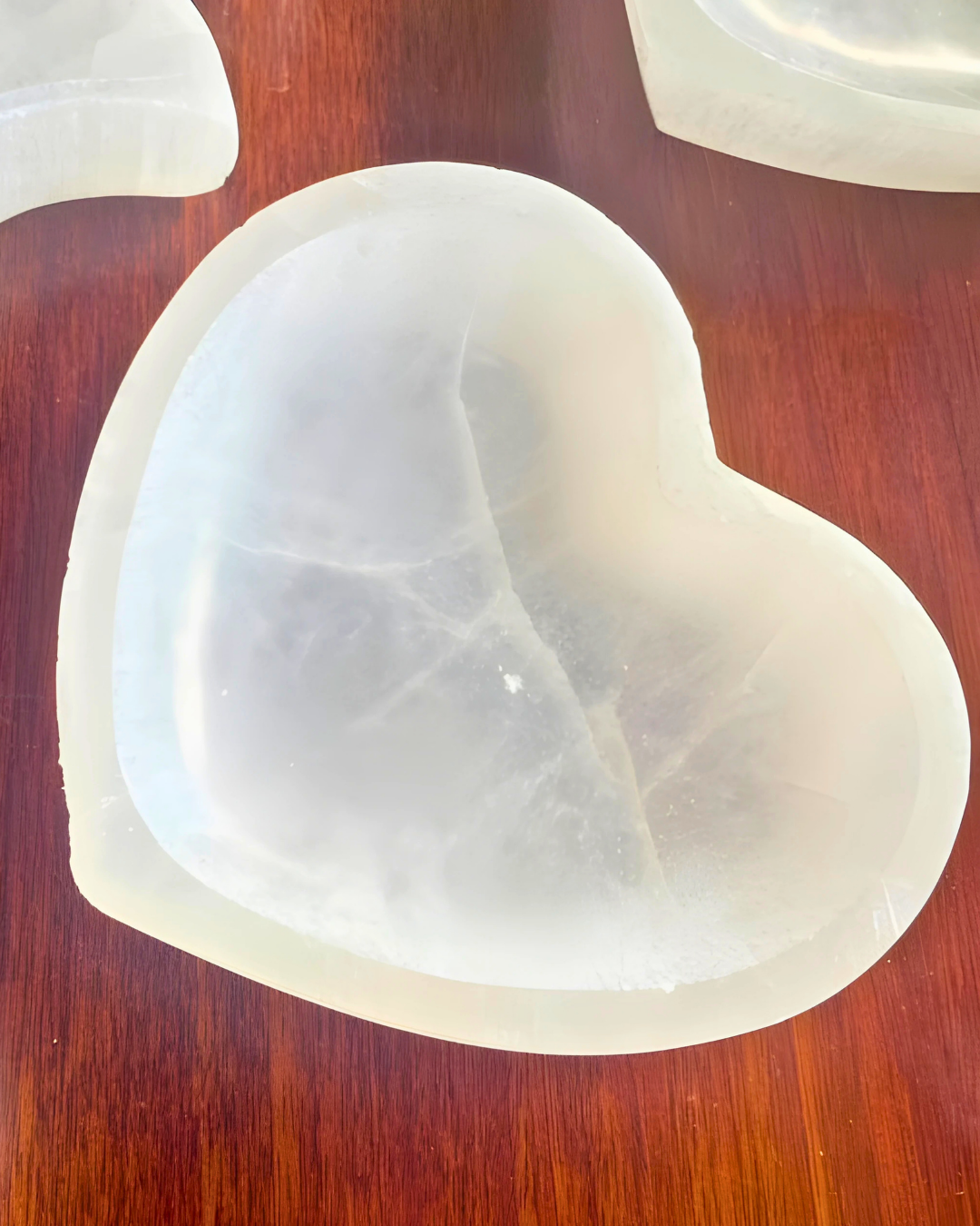 Heart-shaped white object on a wooden surface