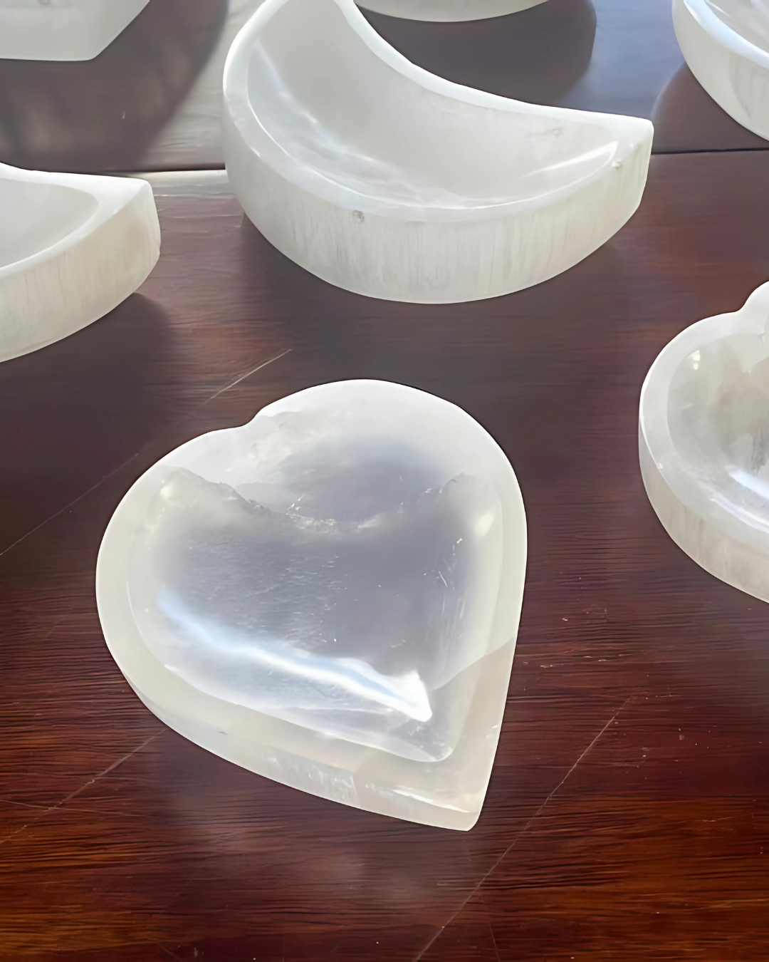 Heart-shaped white stone on a wooden surface