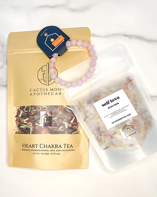 Cactus Moon Apothecary Heart Chakra Tea package with a bracelet and bath bomb on a white background