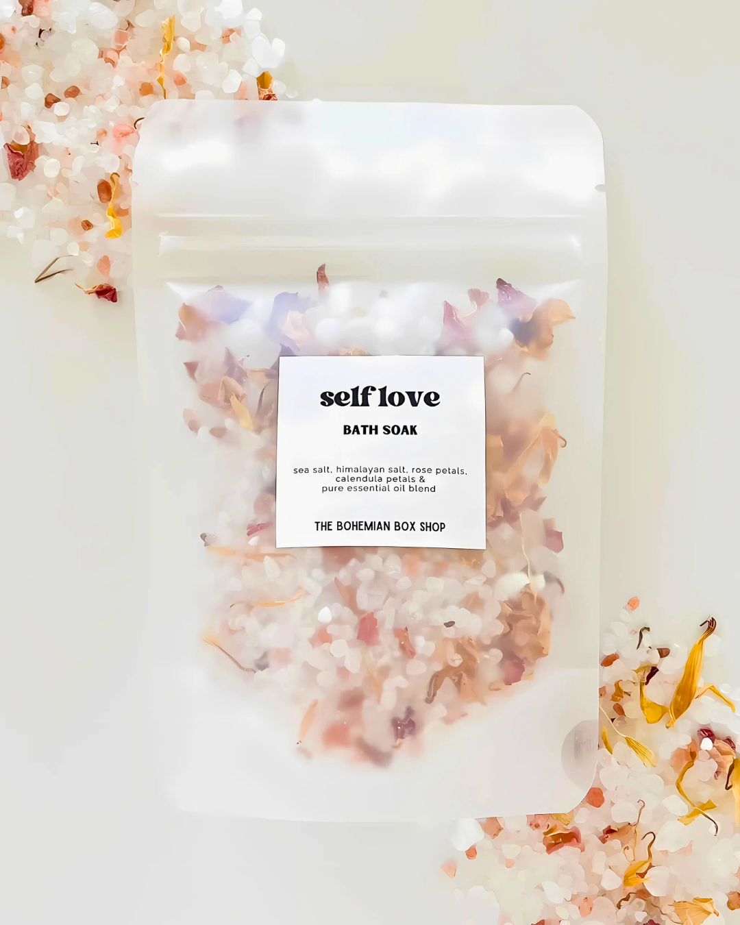 Bath soap package with 'self love' label and floral elements on a light background