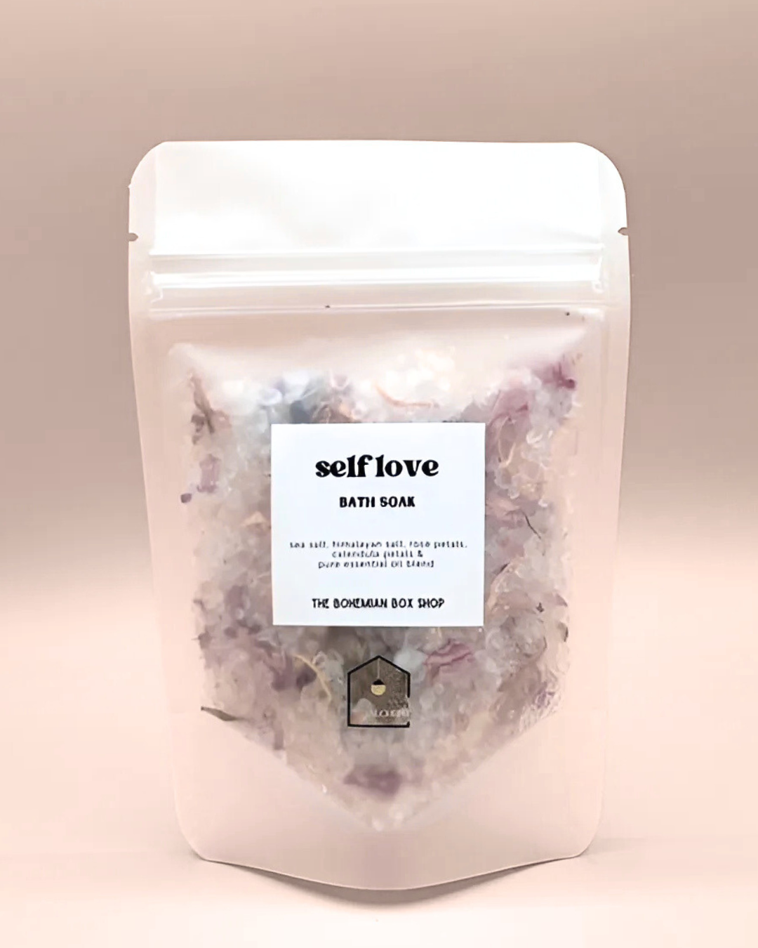 Self love bath soak packaging with a label on a beige background