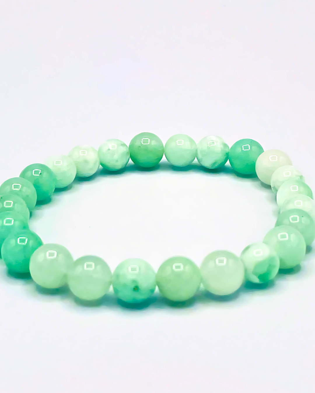 Green beaded bracelet on a white background