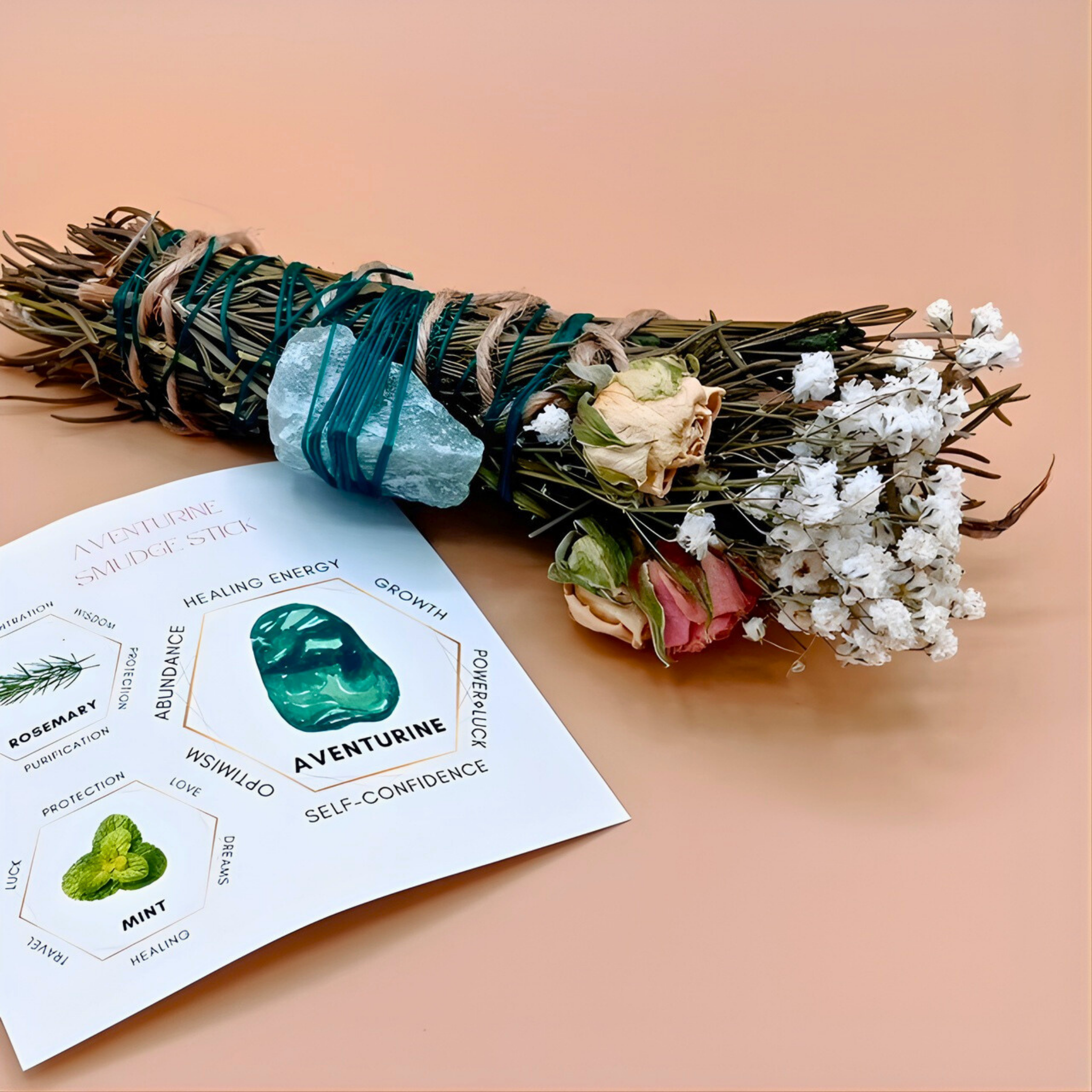 Sage bundle with flowers and a card on a peach background