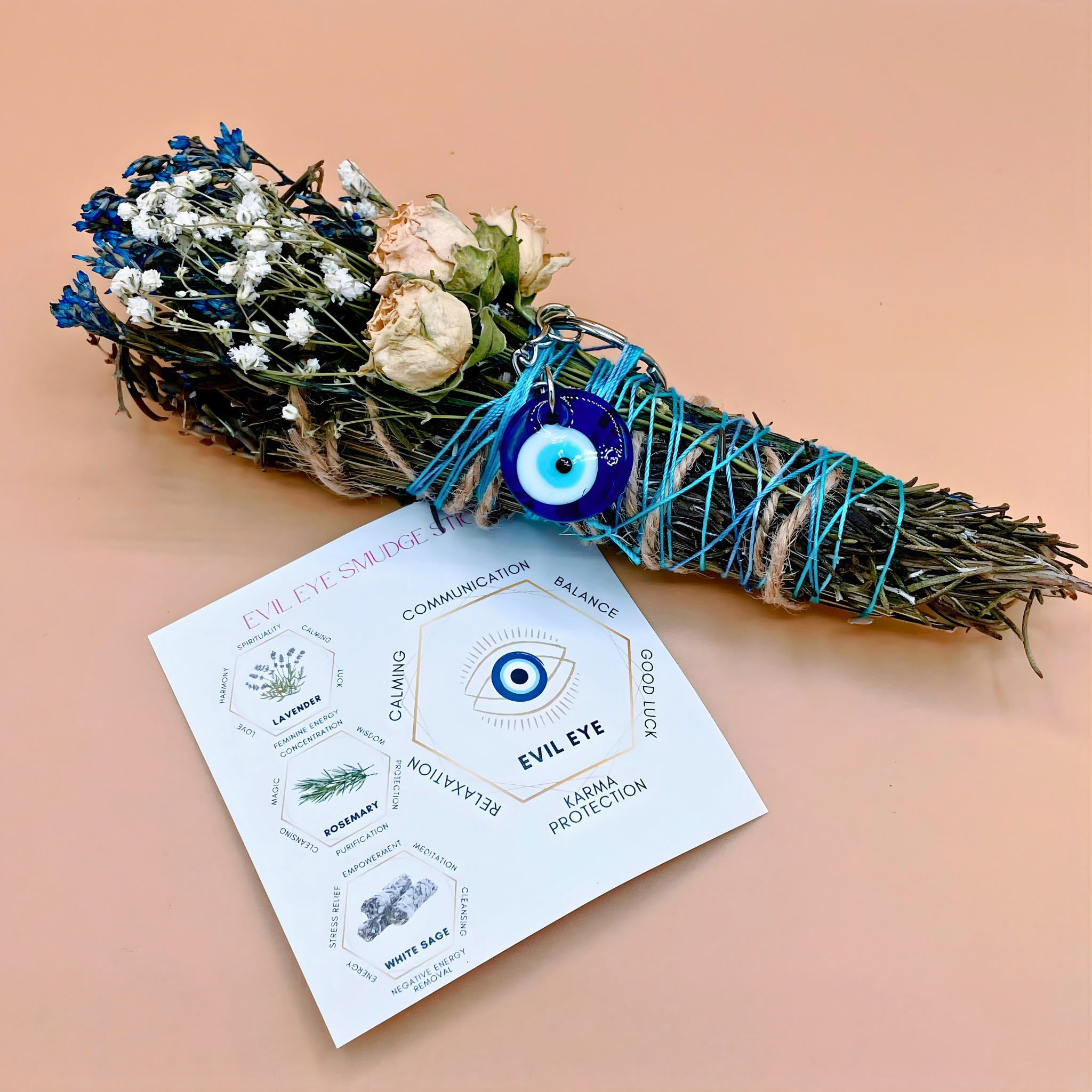 Smudge stick with flowers and evil eye charm on a card with text on a beige background