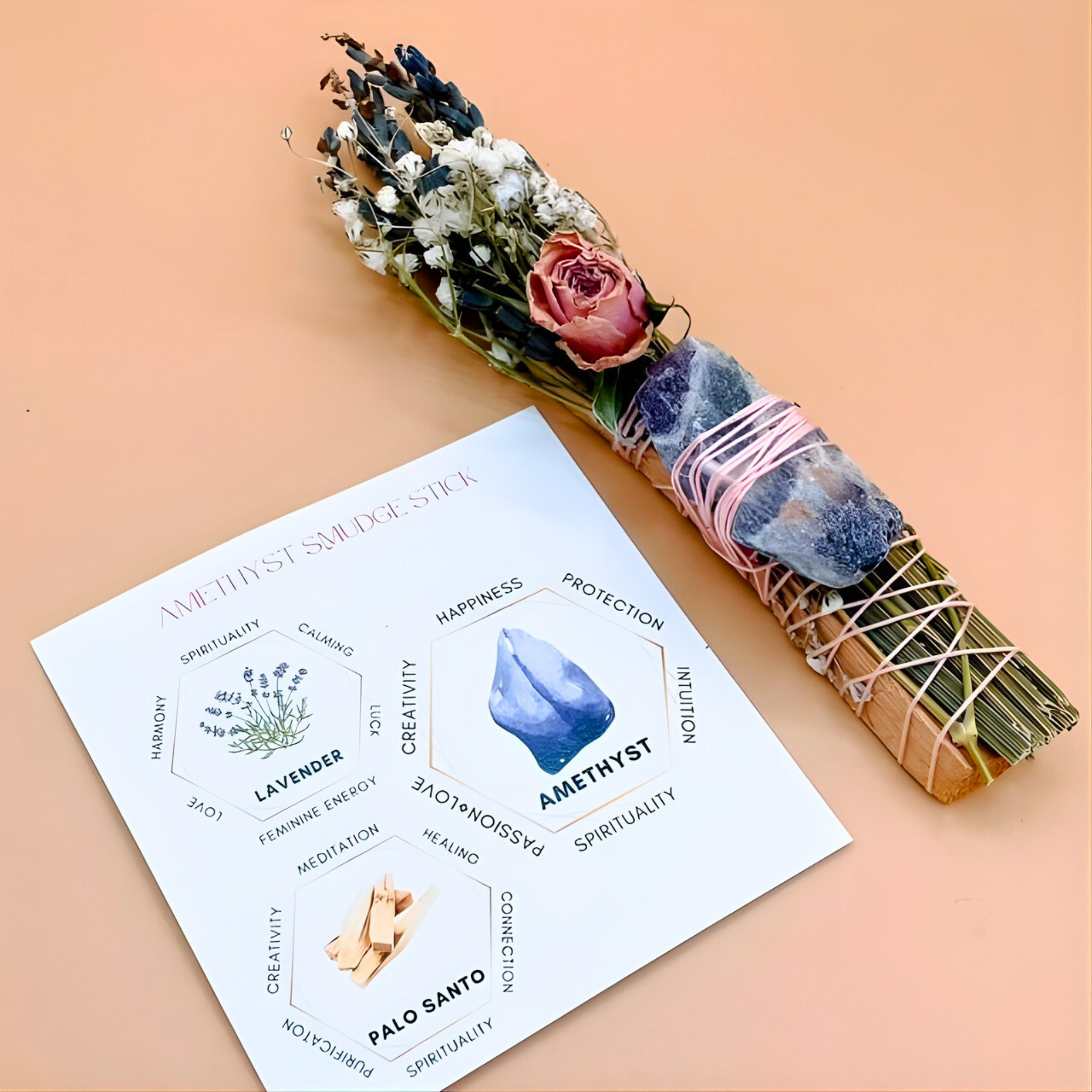 Amenity stick with amethyst crystal and flowers on a card with energy benefits on a peach background