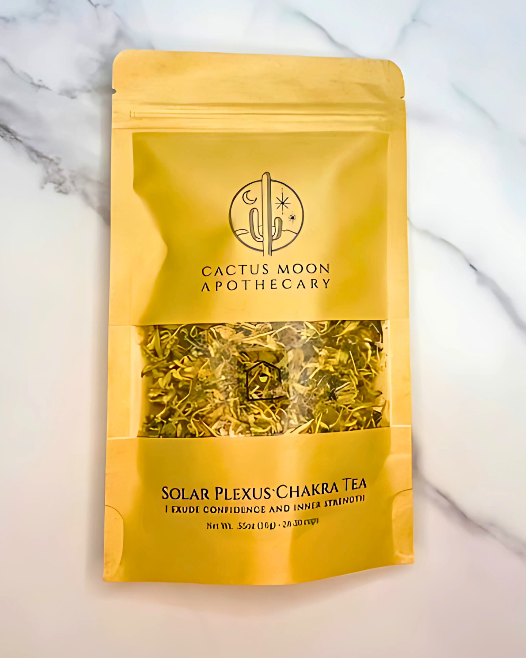 Yellow package of Cactus Moon Apothecary Solar Plexus Chakra Tea on a marble background