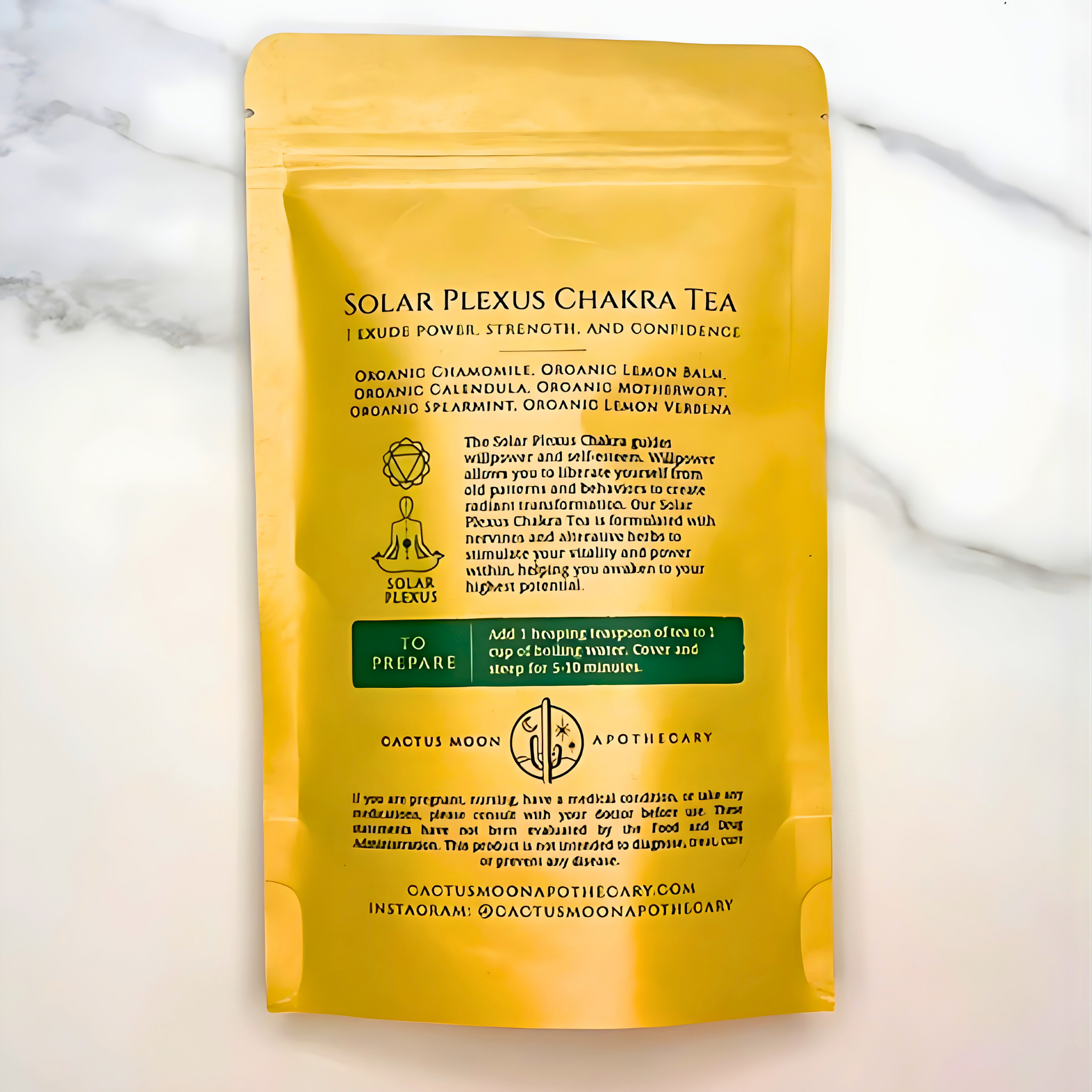 Yellow package of Solar Plexus Chakra Tea on a marble background