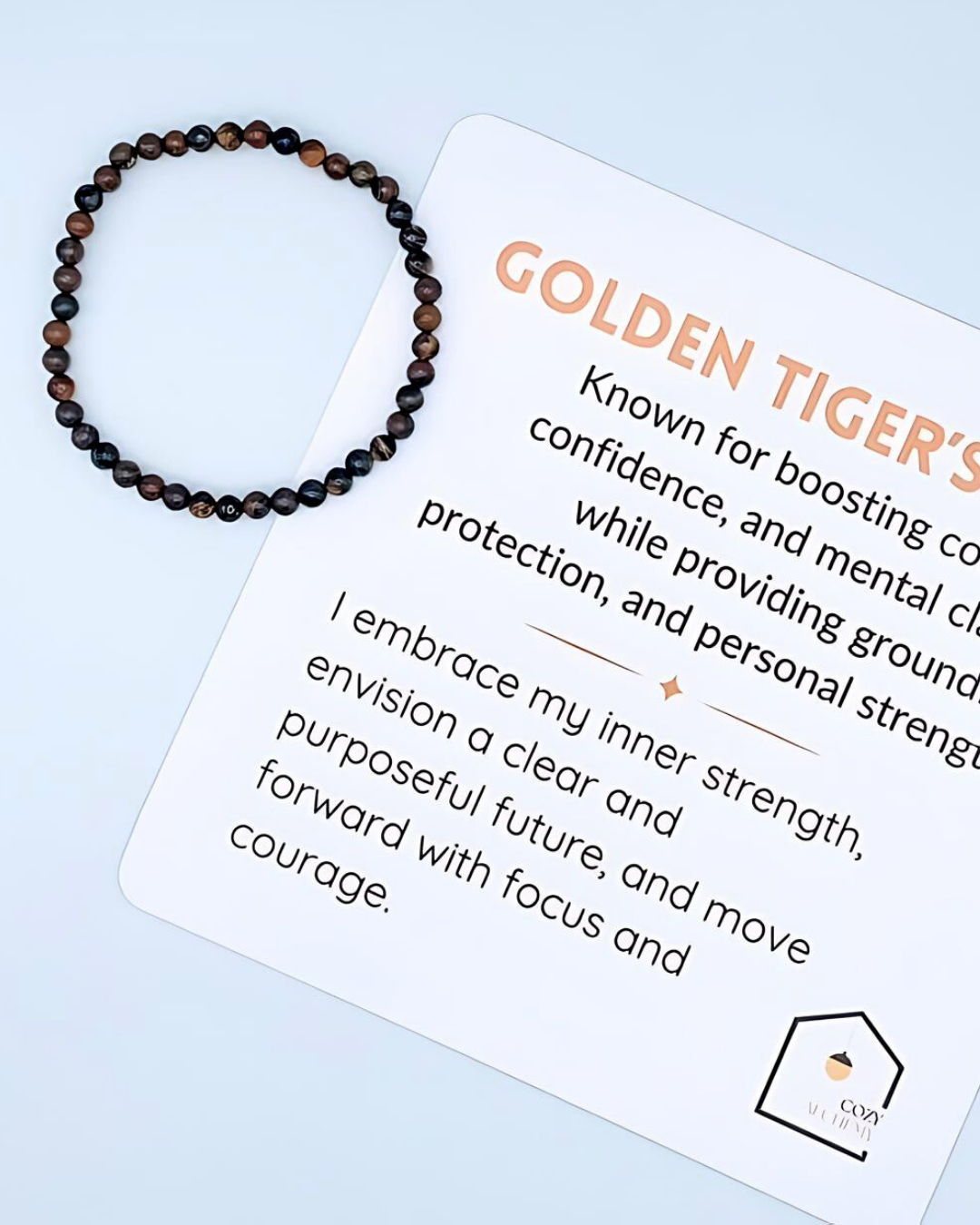 Beaded bracelet on a card with 'Golden Tiger's' text and branding on a light blue background
